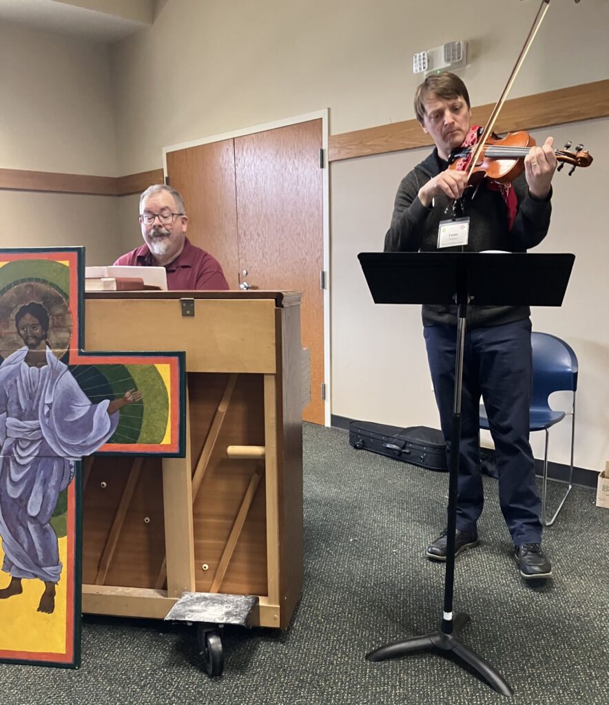 Man playing piano and man playing violin